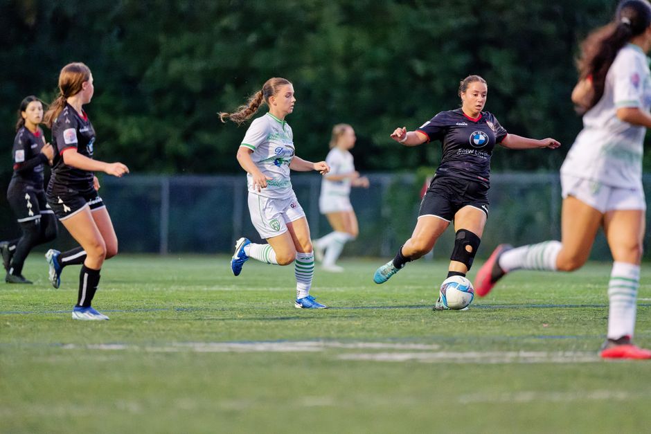 Dynamic scene from a women's soccer match, capturing players in motion on the field.